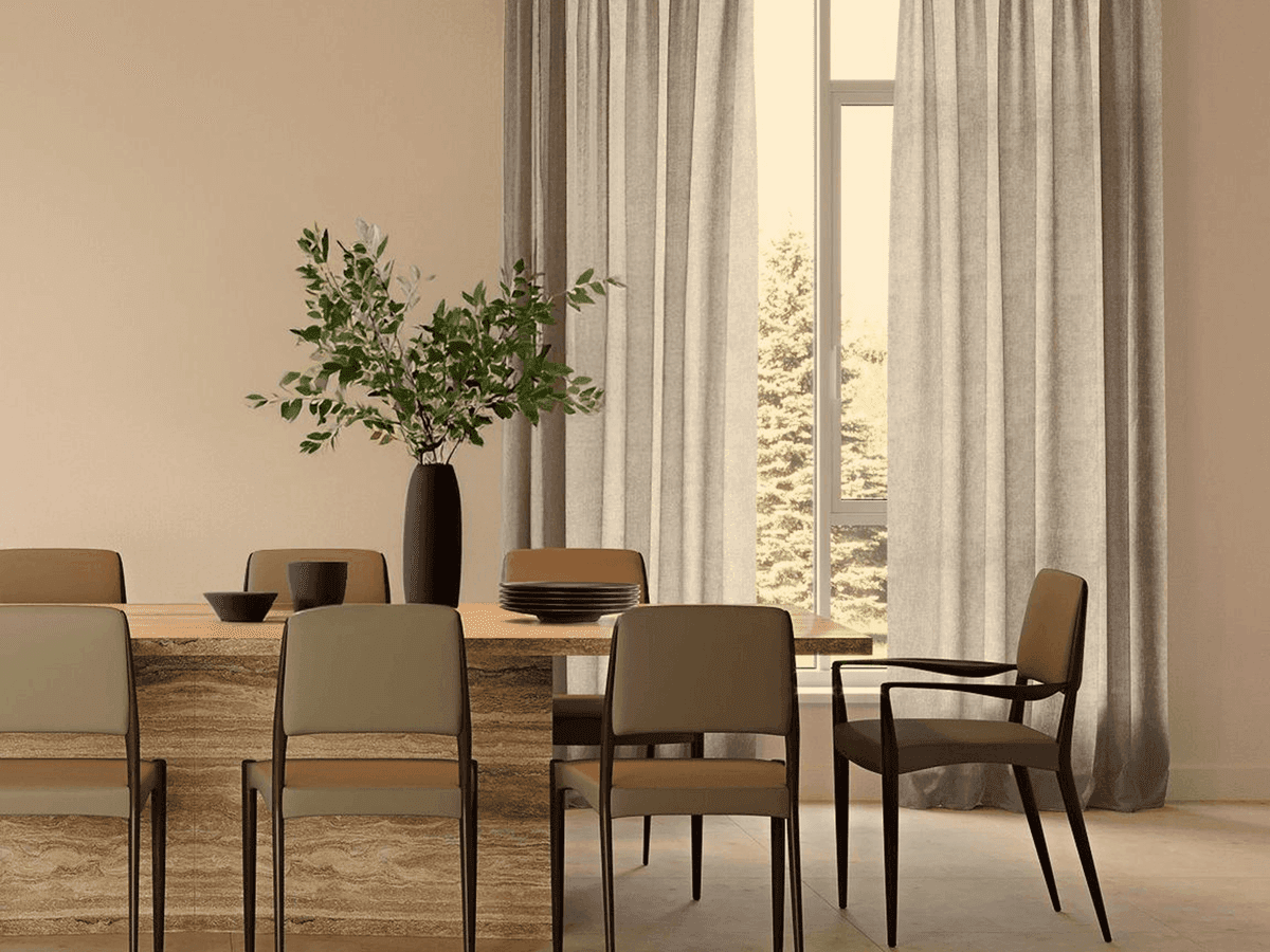 A dining table set against sheer curtains in late afternoon light